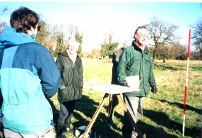 Steve Kemp helping the group to use the plane table. Long  shadows from the Winter sun made it clear where to put the measuring pole.